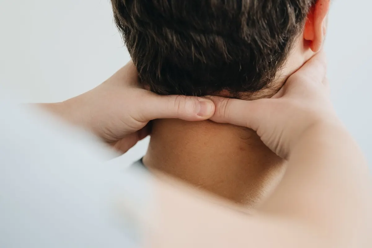 A therapist treating a patient's neck